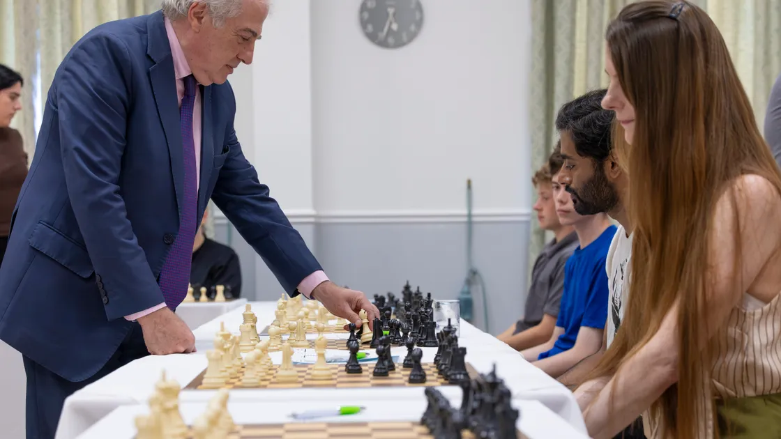 French chess grandmaster Bachar Kouatly moves from board to board during the simultaneous match exhibition at Les Cotils.  