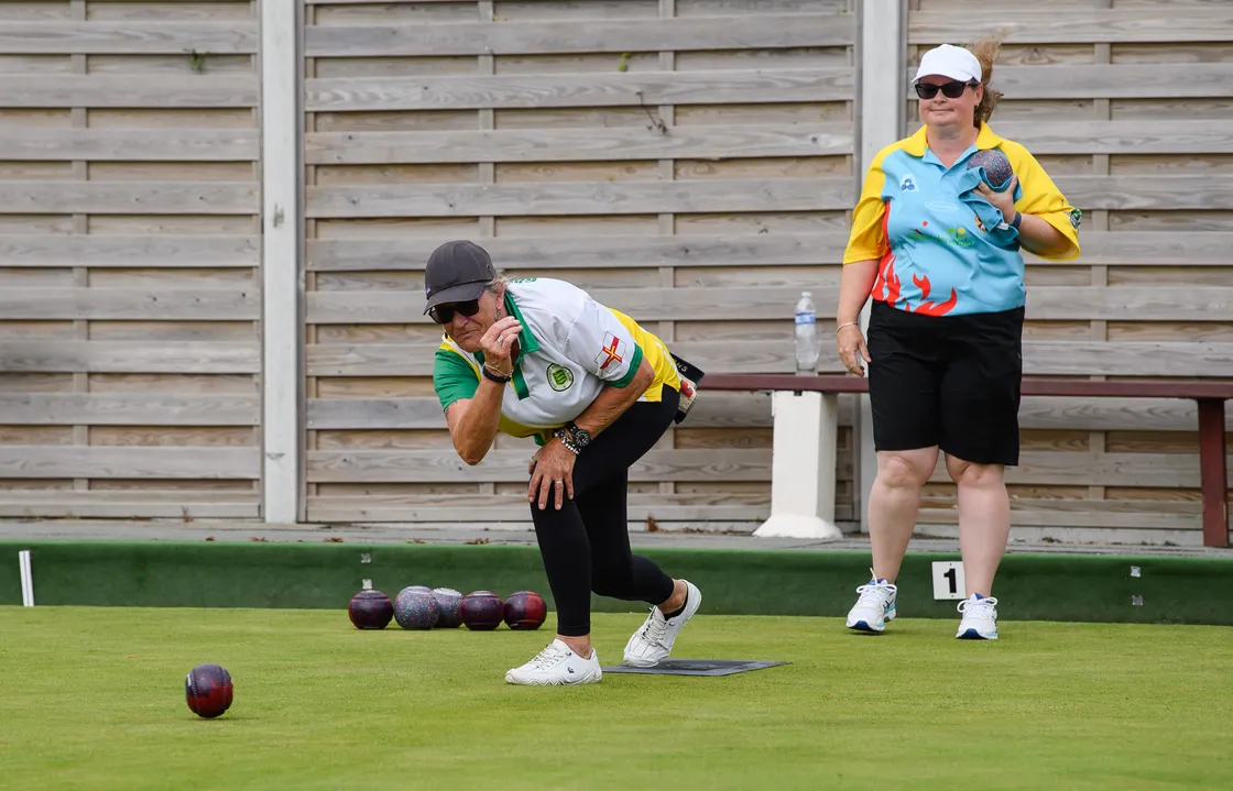 Sue Cosgrave bowls as opponent Lucy Beere looks on in the women’s singles.