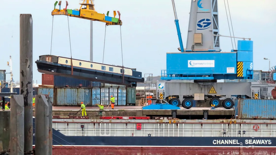 The first of the luxury barges is craned ashore before heading to Beaucette Marina, where it will be used as a home. It is set to be joined by others, possibly up to 20. (Picture by Tony Rive)