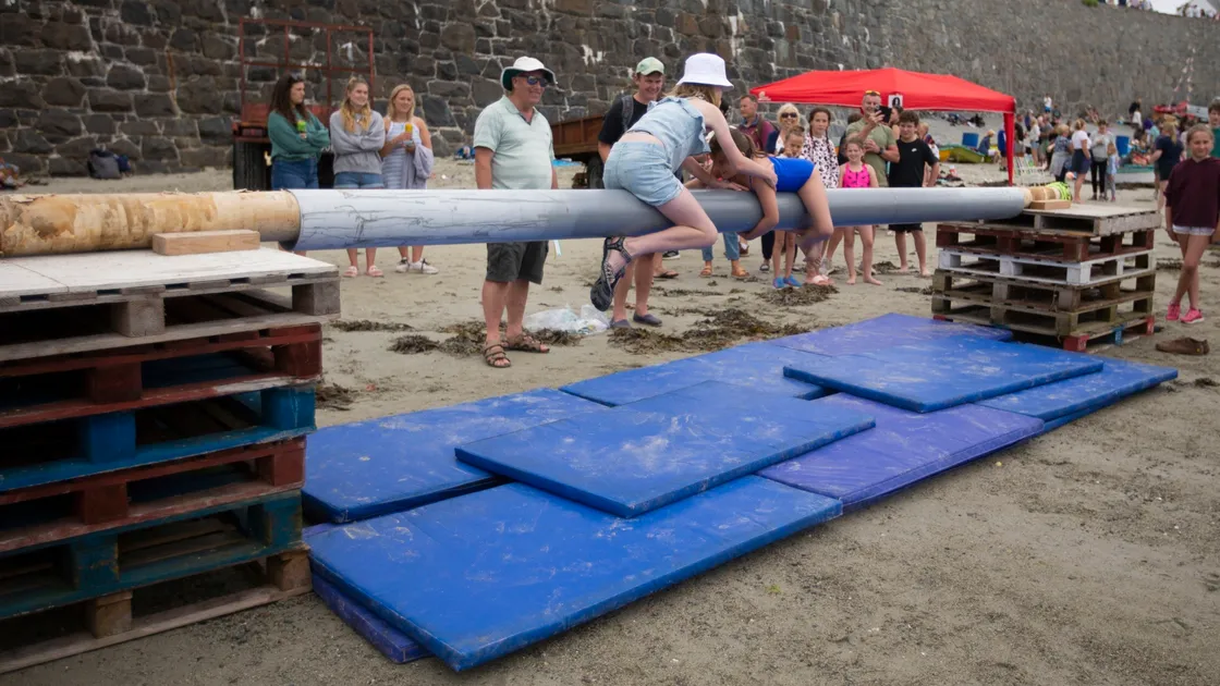 Holly Moore, left, 11, and Cora Blampied, 8, battle on the greasy pole.(29822210)