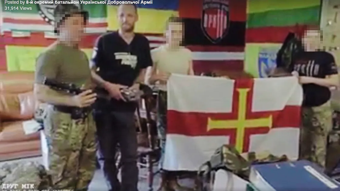 Mikus Alps, second left, appearing in an online Ukranian army video complete with Guernsey flag.