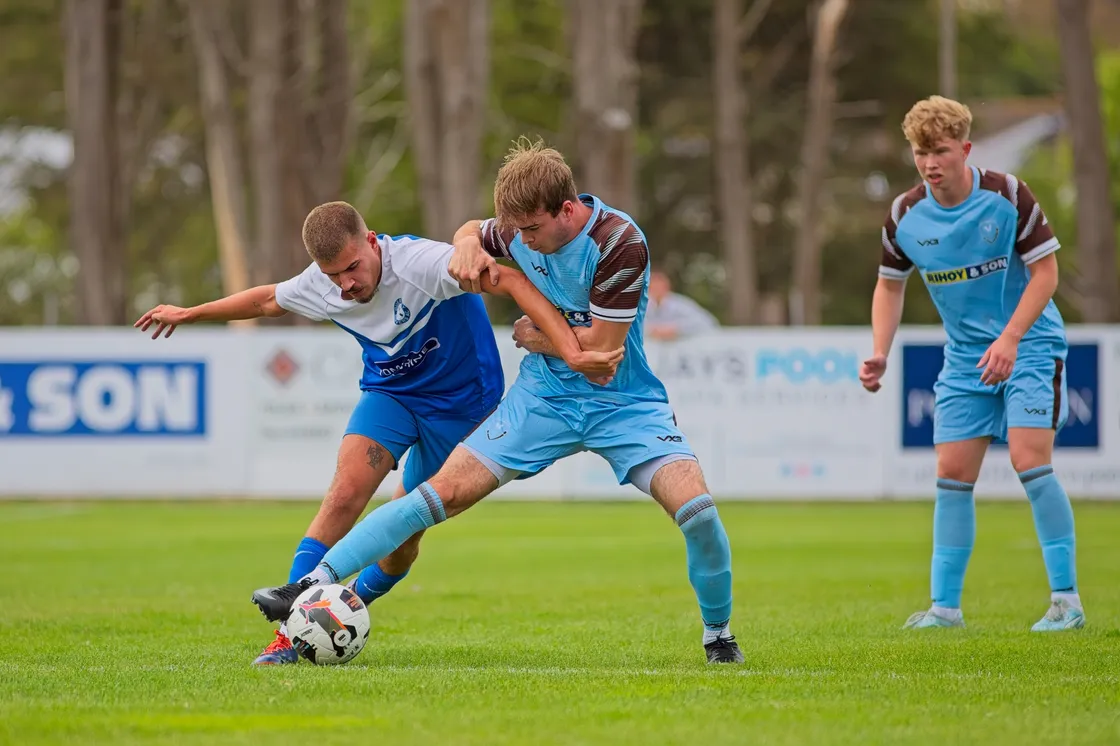 Anthony Santos and Ben Wilson battle for possession.