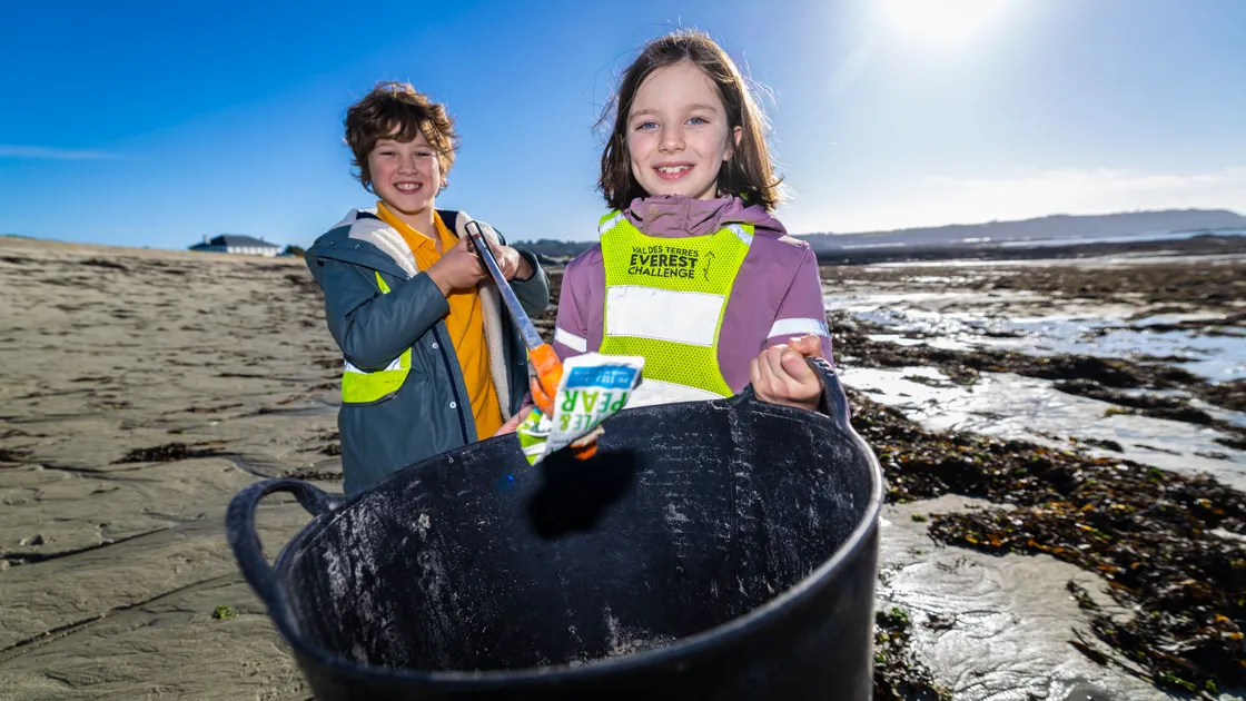 St Martin’s pupils Juno Bamford and Heron Colmer on a beach clean at L’Eree. The school has secured backing from the Strategy for Nature Fund