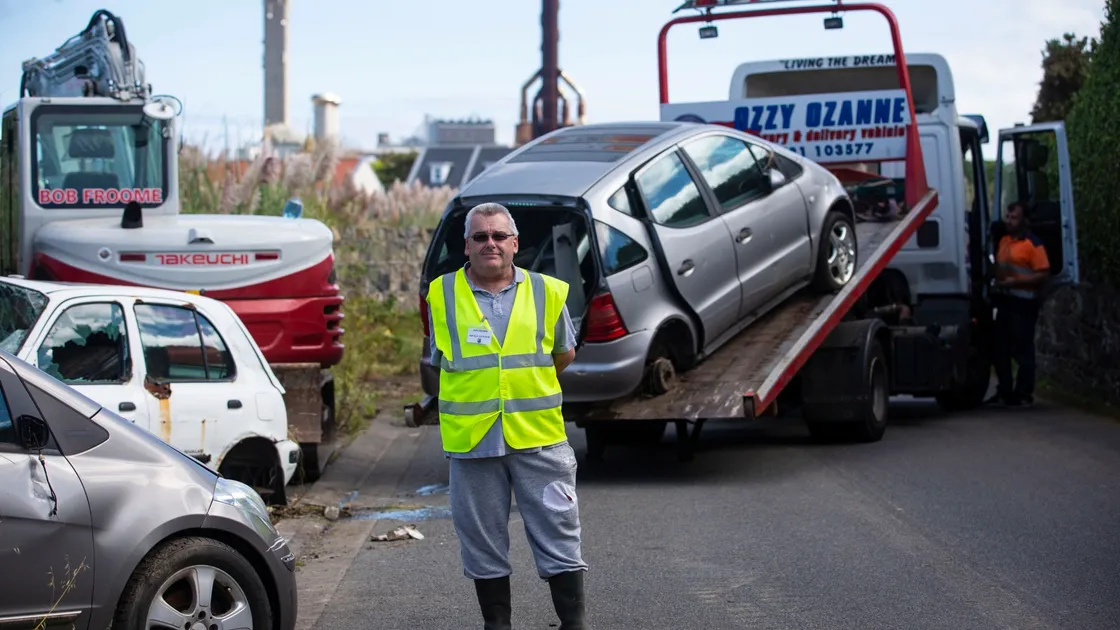 Douzenier Brad Le Flock, who has worked for a long time to get the vehicles removed from Saltpans Road, was on site yesterday as Ozzy Ozanne’s Recoveries and Transport Solutions removed the abandoned vehicles. (Picture by Peter Frankland, 29994596)