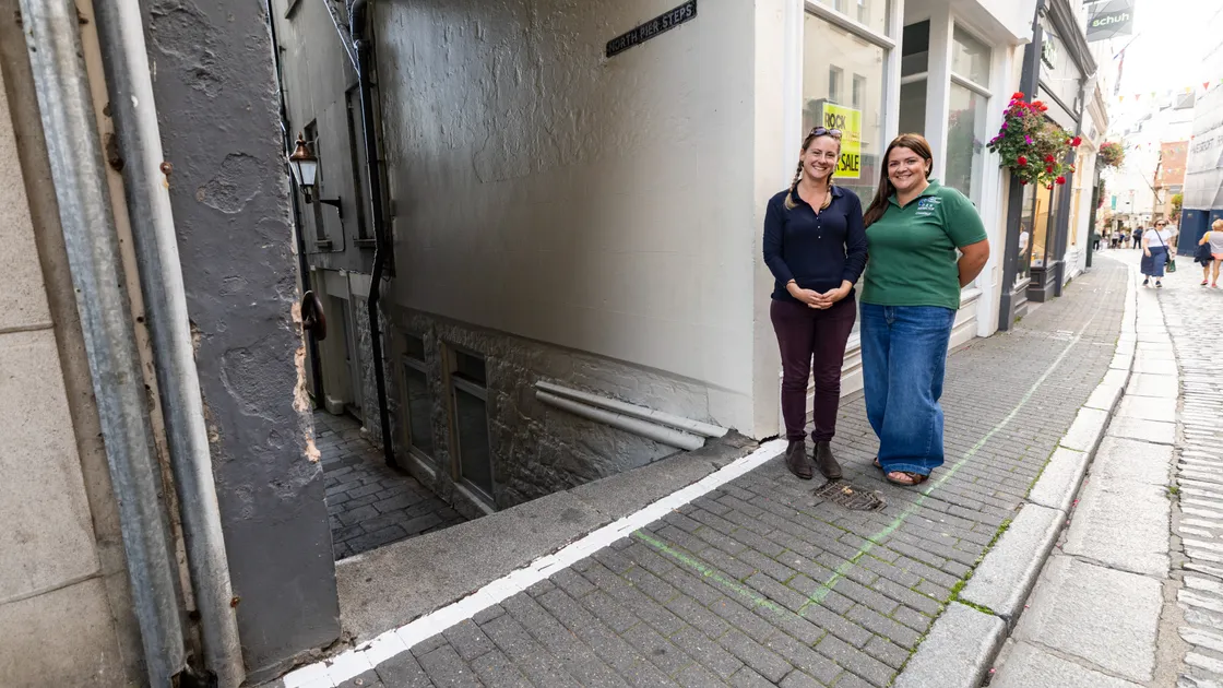 Transport strategy implementation officer, Holly Lindsay, left, and orientation and mobility instructor and vision support services officer at the Guernsey Blind Association, Chantelle Tucker, standing by the white line painted at the top of Pier Steps.