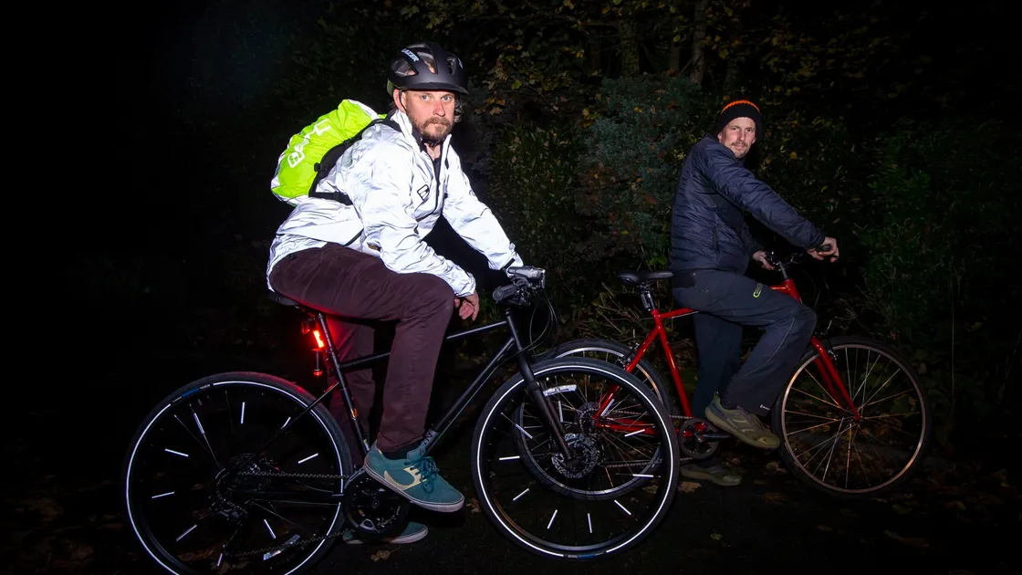 Phil Le Poidevin, left, and Dan Thwaite from the Guernsey Bicycle Group, showing the contrast between a cyclist in hi-vis gear versus someone in dark clothing, as part of Road Safety Week which starts today and runs until Sunday.